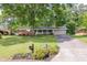 Traditional home with an attached garage, long driveway, and a lush green lawn at 1732 Samaria Trl, Tucker, GA 30084