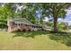 Well-maintained home with brick accents, a landscaped yard, and a large shade tree at 1732 Samaria Trl, Tucker, GA 30084