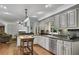 Well-lit kitchen with an island, stainless steel appliances, and open access to the living room at 1732 Samaria Trl, Tucker, GA 30084