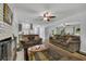 Inviting living room with a fireplace, neutral decor, and a seamless flow into the dining and kitchen areas at 1732 Samaria Trl, Tucker, GA 30084
