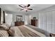 Bright main bedroom with large closets, a ceiling fan, and ensuite bathroom access at 1732 Samaria Trl, Tucker, GA 30084