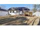 Rear exterior view with a raised wooden deck in the backyard surrounded by lawn at 3279 Greenhill Dr, Villa Rica, GA 30180