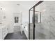 Bathroom with marble tiled shower, a soaking tub, and stylish fixtures, all under natural lighting at 3279 Greenhill Dr, Villa Rica, GA 30180