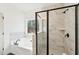 Bathroom featuring marble tile, soaking tub, and seamless glass enclosed shower at 3279 Greenhill Dr, Villa Rica, GA 30180