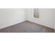 Bright bedroom featuring neutral carpet, white walls, and a window at 3279 Greenhill Dr, Villa Rica, GA 30180