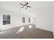 Spacious bedroom with carpet flooring, ceiling fan, and plenty of natural light from the windows at 3279 Greenhill Dr, Villa Rica, GA 30180