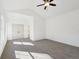 Bright bedroom featuring plush carpeting, ceiling fan, and ample natural light from large windows at 3279 Greenhill Dr, Villa Rica, GA 30180