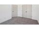 Bright bedroom featuring neutral carpet, white walls, and doors at 3279 Greenhill Dr, Villa Rica, GA 30180