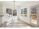 Bright breakfast area with hardwood floors offers access to an outdoor deck and scenic views of the surrounding woods at 3279 Greenhill Dr, Villa Rica, GA 30180