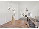 Hardwood floors and modern lighting define this dining area connected to the open floor plan living room and kitchen at 3279 Greenhill Dr, Villa Rica, GA 30180