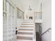 Bright entryway with wood floors, an open staircase, and a view into the open floorplan at 3279 Greenhill Dr, Villa Rica, GA 30180