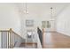 Bright entryway with wood floors, an open staircase, and a view into the adjacent living area at 3279 Greenhill Dr, Villa Rica, GA 30180