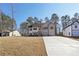 Charming two-story home with a symmetrical design, featuring a long concrete driveway and manicured lawn at 3279 Greenhill Dr, Villa Rica, GA 30180