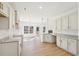 Open concept kitchen and dining area with white cabinets, granite countertops, and modern lighting at 3279 Greenhill Dr, Villa Rica, GA 30180