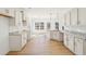 Bright kitchen with island, white cabinets, granite countertops and access to the dining area at 3279 Greenhill Dr, Villa Rica, GA 30180
