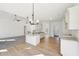 Open-concept kitchen and living area with modern lighting and light wood flooring at 3279 Greenhill Dr, Villa Rica, GA 30180