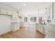 Open concept kitchen and dining area with white cabinets, granite countertops, and light wood floors at 3279 Greenhill Dr, Villa Rica, GA 30180