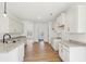 Spacious kitchen features white cabinets, granite countertops, and light wood flooring at 3279 Greenhill Dr, Villa Rica, GA 30180
