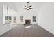 Sun-filled living room with plush carpet, stone fireplace, and an adjacent kitchen with bar seating at 3279 Greenhill Dr, Villa Rica, GA 30180