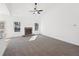 Sun-filled living room with plush carpet, stone fireplace, and an adjacent kitchen with bar seating at 3279 Greenhill Dr, Villa Rica, GA 30180