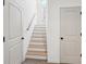 Staircase with white risers and wood treads, complemented by white doors and trim at 3279 Greenhill Dr, Villa Rica, GA 30180