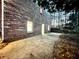 Backyard view showcasing the brick exterior, concrete patio, and mature trees at 342 Mccurry Rd, Stockbridge, GA 30281