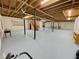 Unfinished basement with painted floor, exposed ceiling, support columns, and stairs at 342 Mccurry Rd, Stockbridge, GA 30281