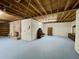 Large unfinished basement featuring a brick fireplace, wood rafters and painted floor at 342 Mccurry Rd, Stockbridge, GA 30281