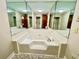 Bathroom featuring a corner jacuzzi tub surrounded by mirrors and tile at 342 Mccurry Rd, Stockbridge, GA 30281