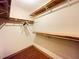 Walk-in closet with wood-look floors and built-in shelving for organized storage at 342 Mccurry Rd, Stockbridge, GA 30281