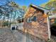 Brick home exterior showcasing a covered porch, green shutters, and manicured landscaping at 342 Mccurry Rd, Stockbridge, GA 30281