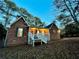 Charming brick home with a welcoming front porch and green shutters at twilight at 342 Mccurry Rd, Stockbridge, GA 30281