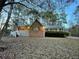 Charming brick home with a welcoming front porch and green shutters at twilight at 342 Mccurry Rd, Stockbridge, GA 30281