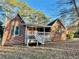 A charming brick home featuring a welcoming front porch with white railings and a cozy entryway at 342 Mccurry Rd, Stockbridge, GA 30281