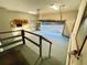Spacious garage with painted floors, stairs, storage shelves, and an open door to the outdoors at 342 Mccurry Rd, Stockbridge, GA 30281