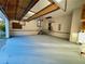 Spacious garage with painted floors, stairs, storage shelves, and an open door to the outdoors at 342 Mccurry Rd, Stockbridge, GA 30281