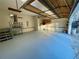 Spacious garage with painted floors, stairs, storage shelves, and an open door to the outdoors at 342 Mccurry Rd, Stockbridge, GA 30281