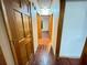 Hallway with hardwood floors leads to rooms with wooden doors and white walls at 342 Mccurry Rd, Stockbridge, GA 30281