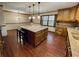 Open concept kitchen featuring a large island with seating, wood cabinetry, and seamless access to the dining area at 342 Mccurry Rd, Stockbridge, GA 30281