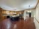 Open kitchen with wood cabinets, granite countertops, central island with seating, and modern lighting at 342 Mccurry Rd, Stockbridge, GA 30281