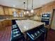 Spacious kitchen features granite countertops, wood cabinets, stainless appliances, and a central island with seating at 342 Mccurry Rd, Stockbridge, GA 30281