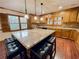 Charming kitchen featuring a large island with seating, granite countertops, wood cabinets, and updated fixtures at 342 Mccurry Rd, Stockbridge, GA 30281