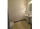 Clean half bathroom features a toilet, sink, and modern fixtures for convenience at 5047 Chupp Way Cir, Lithonia, GA 30038