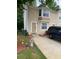 Inviting townhome featuring a front door and a large bay window that brightens the living space at 5047 Chupp Way Cir, Lithonia, GA 30038