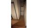 Stackable washer and dryer in a small laundry area with a door and wood floor at 5047 Chupp Way Cir, Lithonia, GA 30038