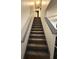 Carpeted staircase leading to the upper level of the home with painted handrail at 5047 Chupp Way Cir, Lithonia, GA 30038