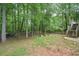 Huge backyard with green grass, garden beds, and a staircase to a deck at 92 Confidence Ct, Temple, GA 30179