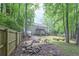 Spacious backyard with green grass, garden beds, and a firepit area at 92 Confidence Ct, Temple, GA 30179