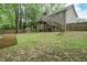 Large backyard featuring a wooden deck, green grass, a fence, and a greenhouse at 92 Confidence Ct, Temple, GA 30179