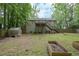 View of a large backyard featuring a wooden deck, green grass, and a greenhouse at 92 Confidence Ct, Temple, GA 30179
